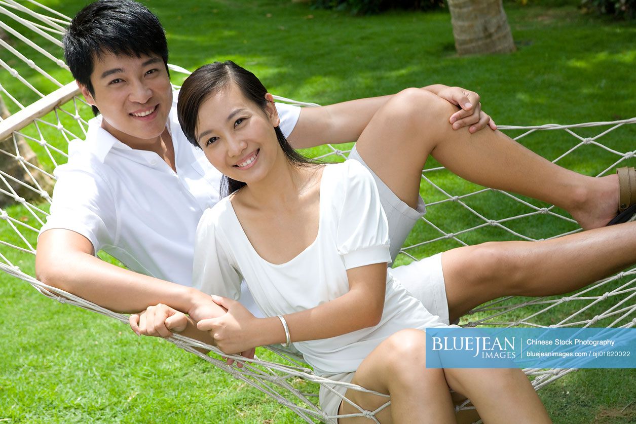 Portrait of a young Chinese couple in a hammock