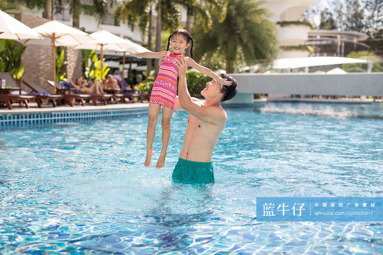 快乐的父女俩在泳池玩耍