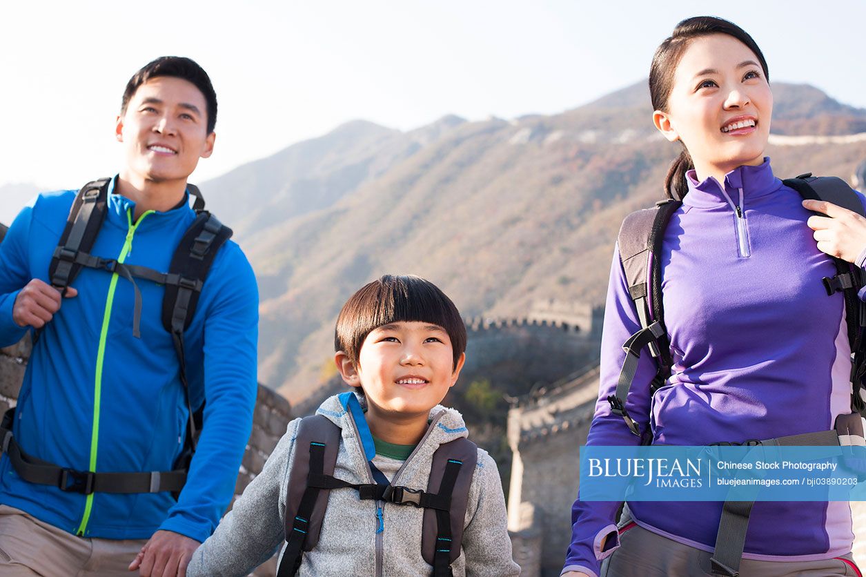 Young Chinese family enjoying autumn outing on Great Wall