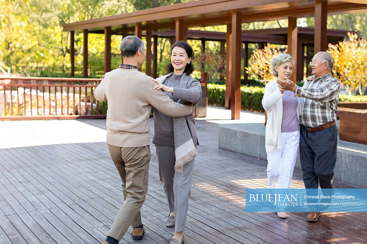 Cheerful senior Chinese adult dancing in the park