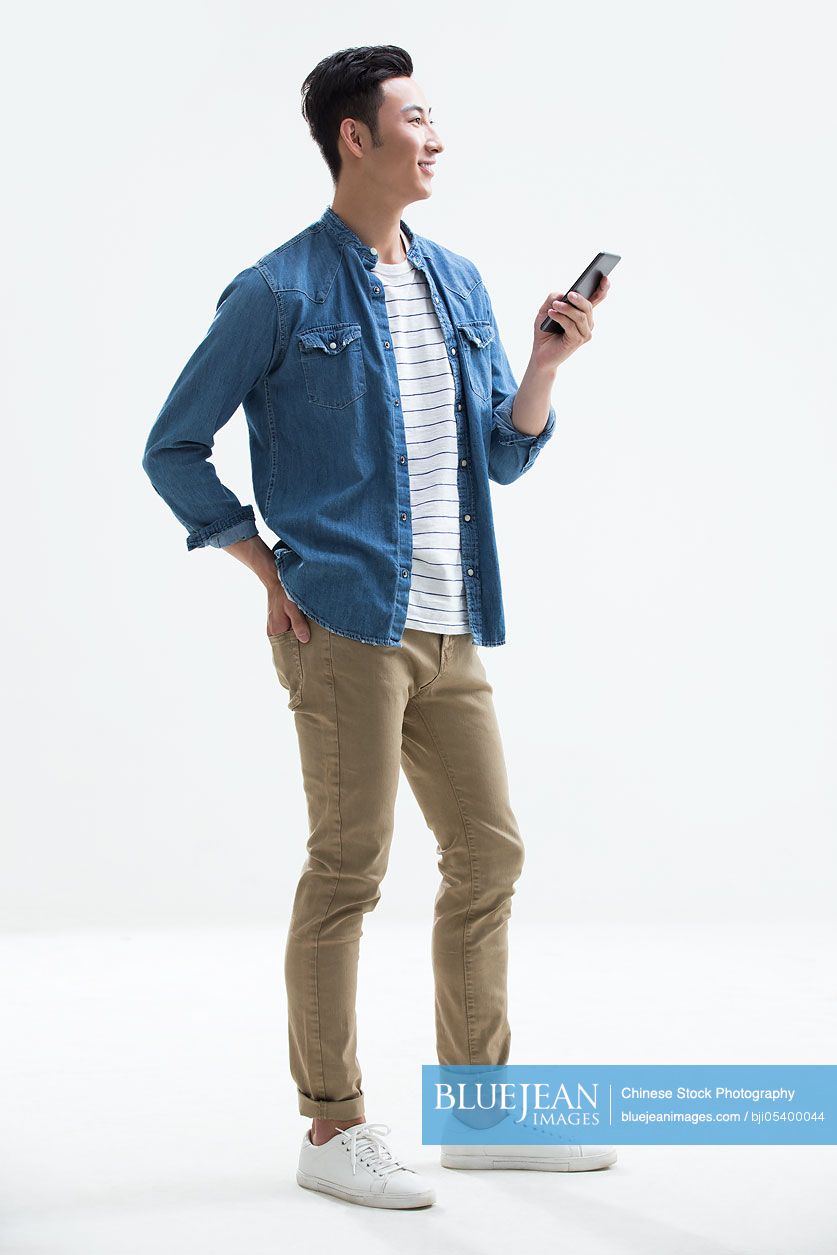 Young Chinese man using smart phone