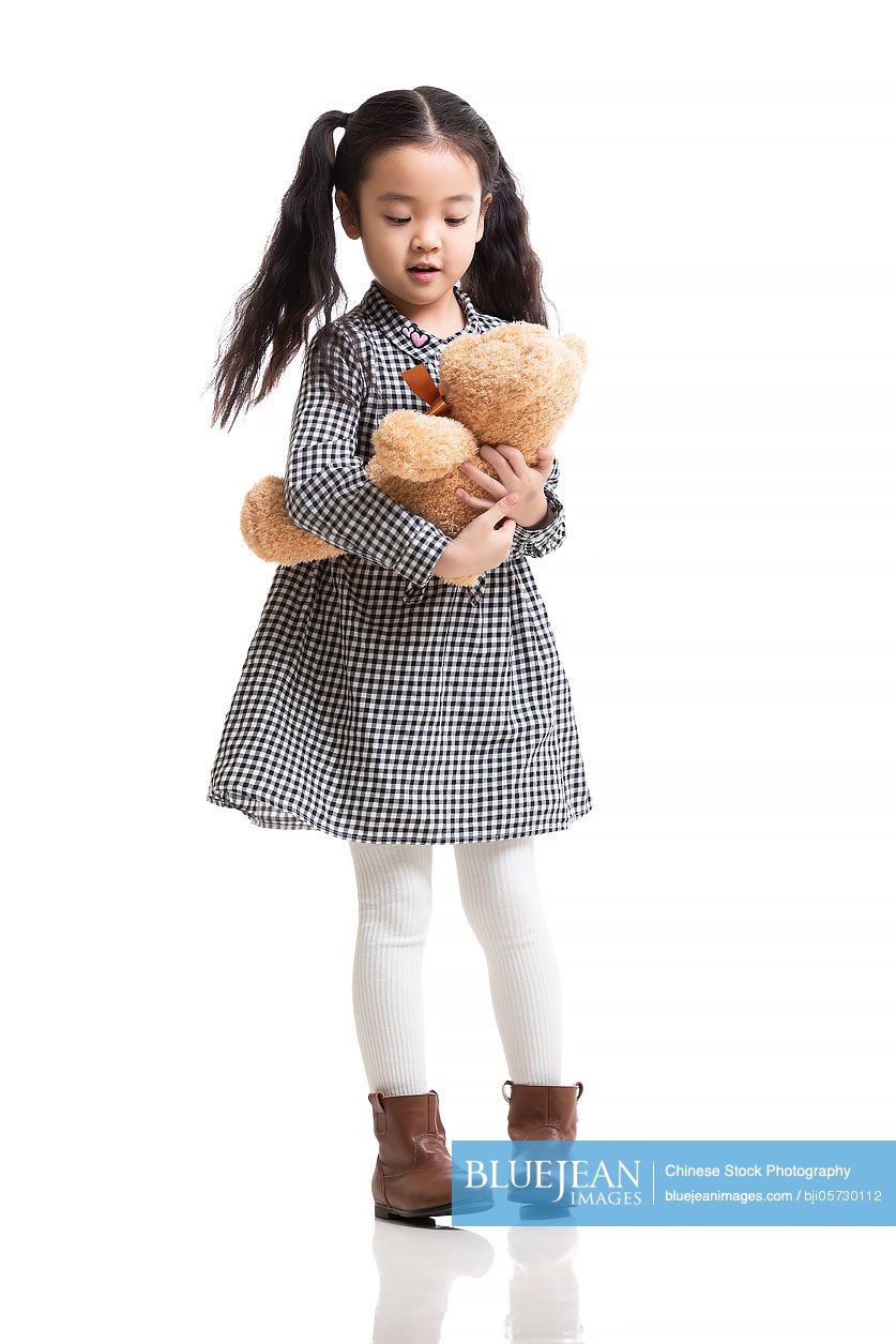 Happy little Chinese girl with teddy bear