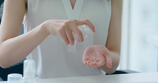 Young Chinese businesswoman using hand sanitizer in office,4K