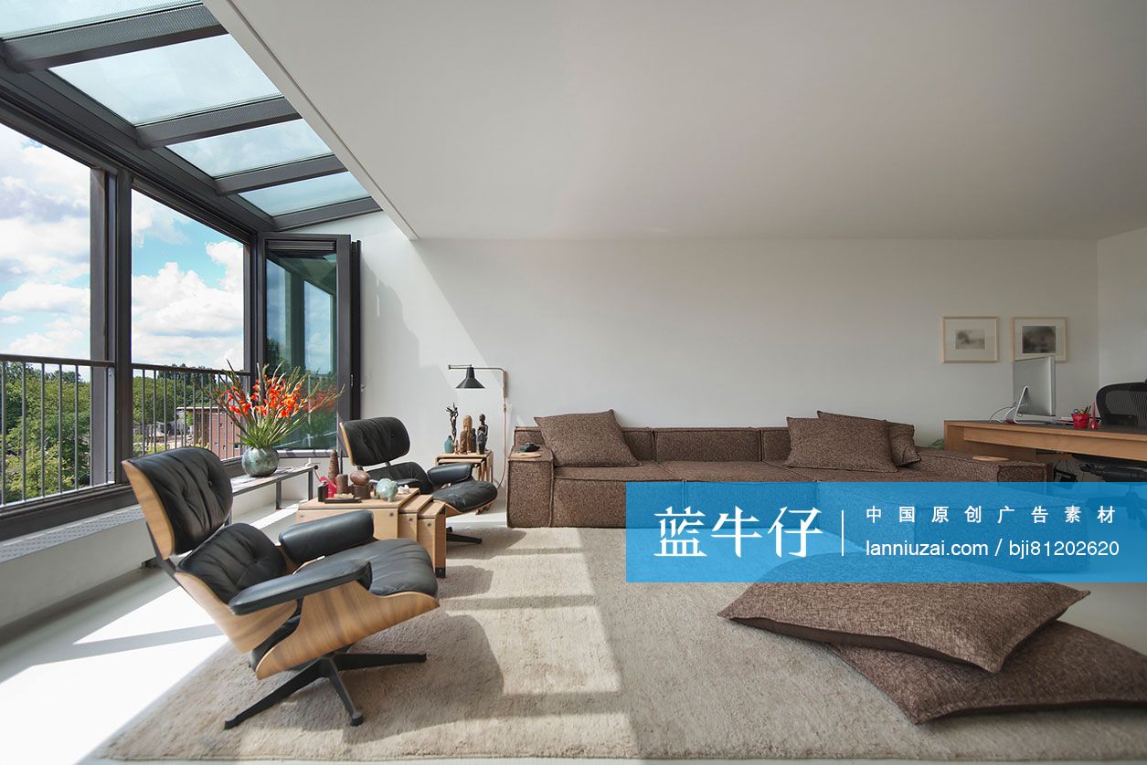 Large living room with rug on floor and view of trees through window