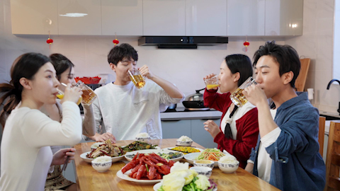 Young friends gathered around the table for a meal