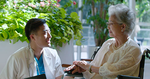Young Chinese doctor talking with senior man in nursing home,4K