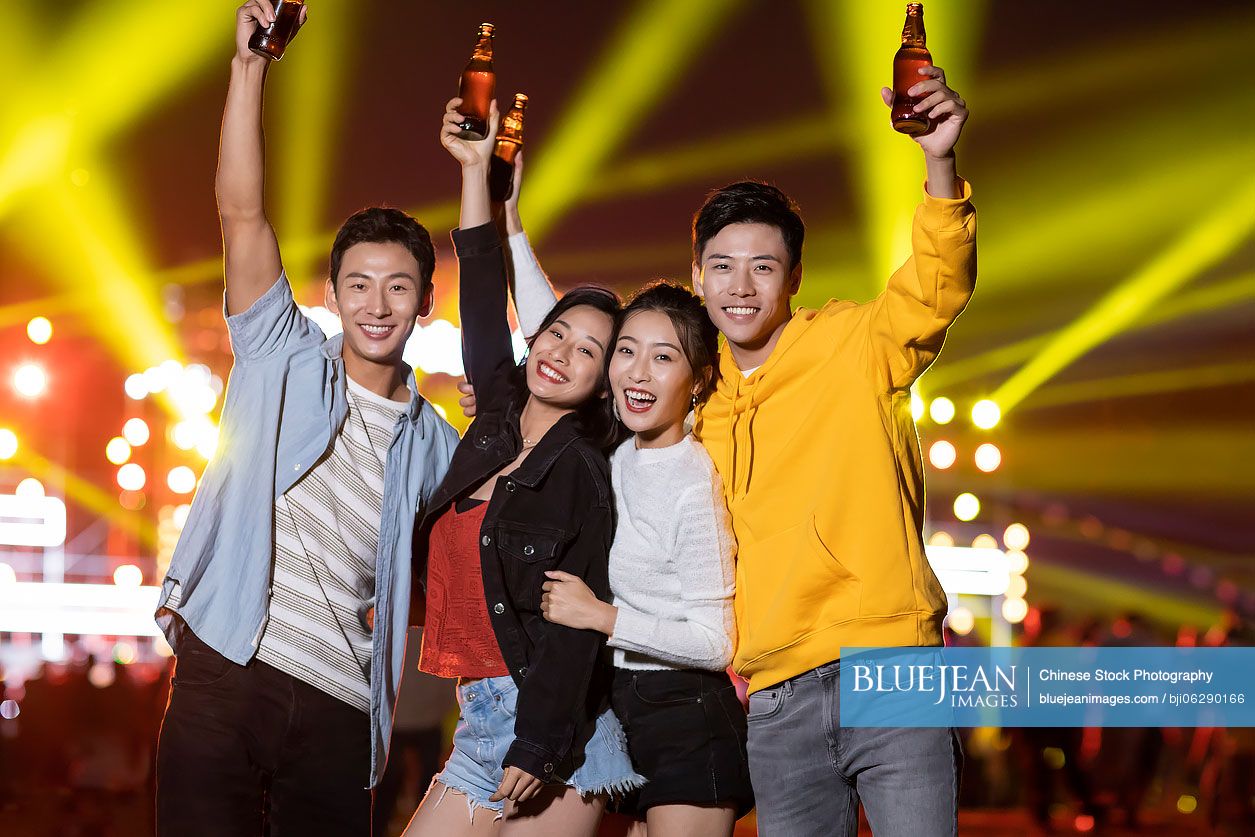Happy young Chinese friends at music festival