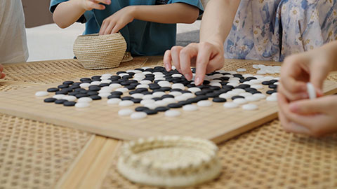 Family enjoying a game of Go in the hotel room
