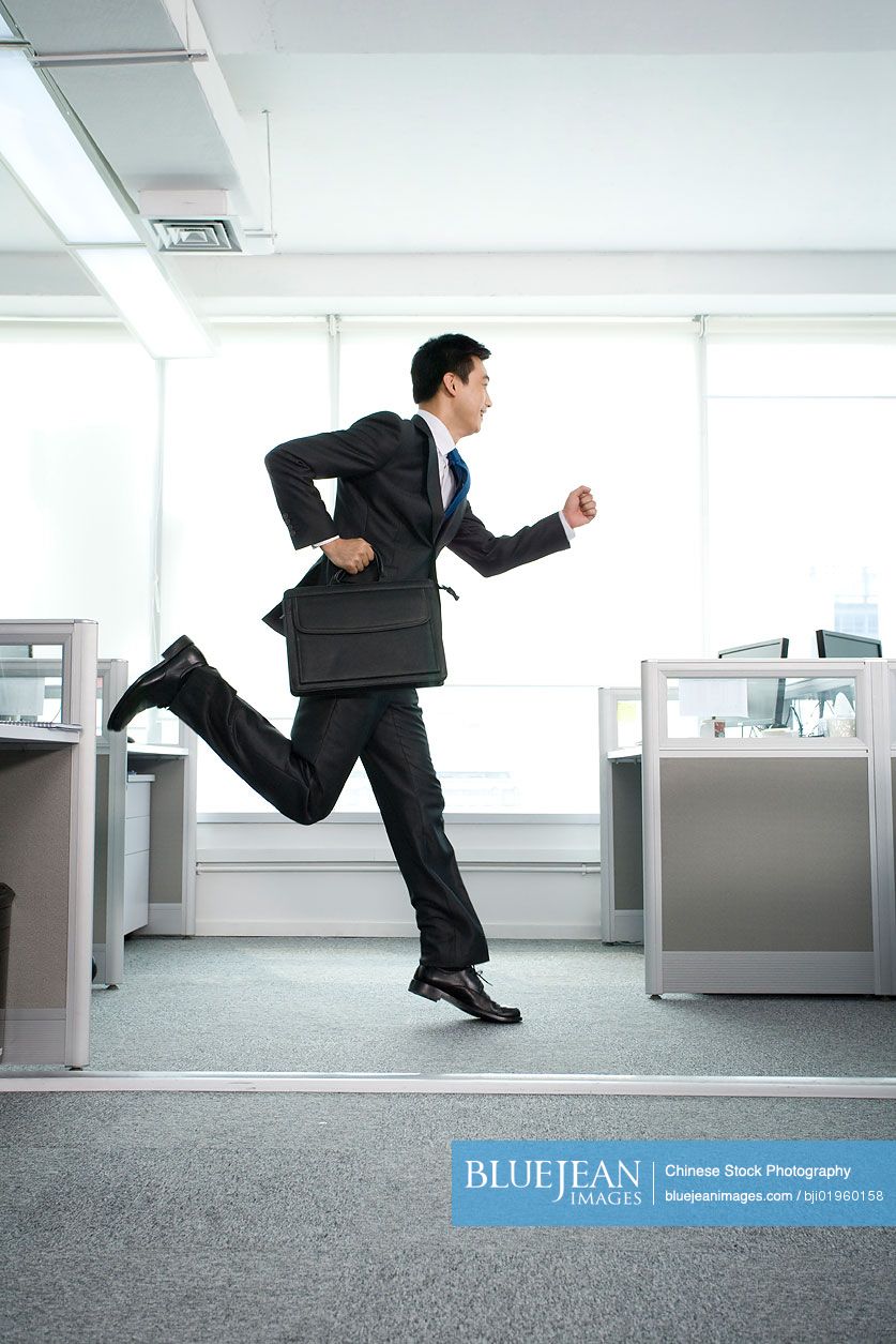 Chinese office worker running around in the office