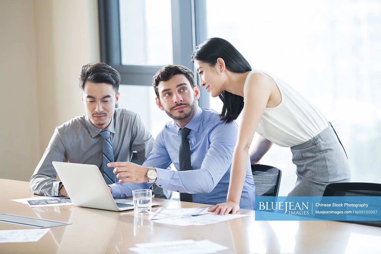 Chinese business people talking in meeting room