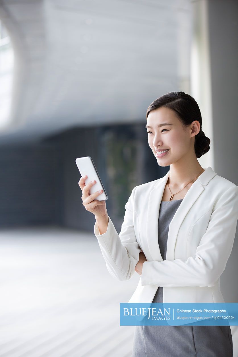 Chinese businesswoman holding a smart phone