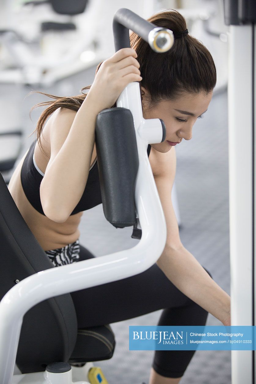 Young Chinese woman resting at gym