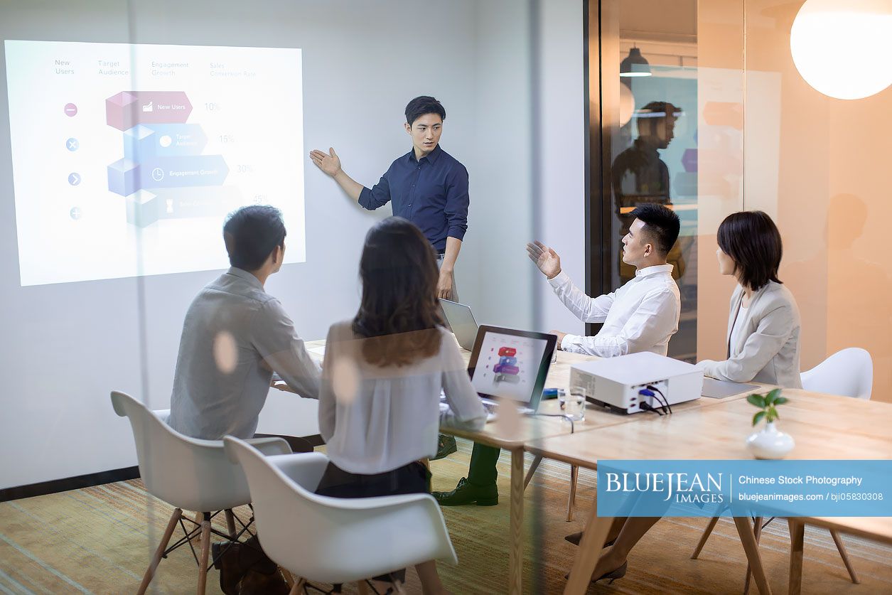 Chinese business people having meeting in board room 