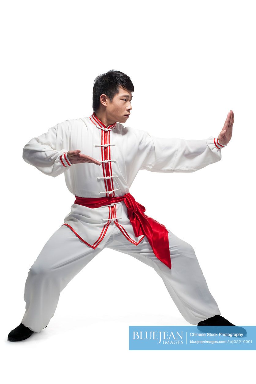 Focused Chinese man doing martial arts in traditional clothing