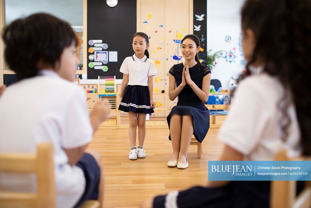 Chinese teacher and children in classroom