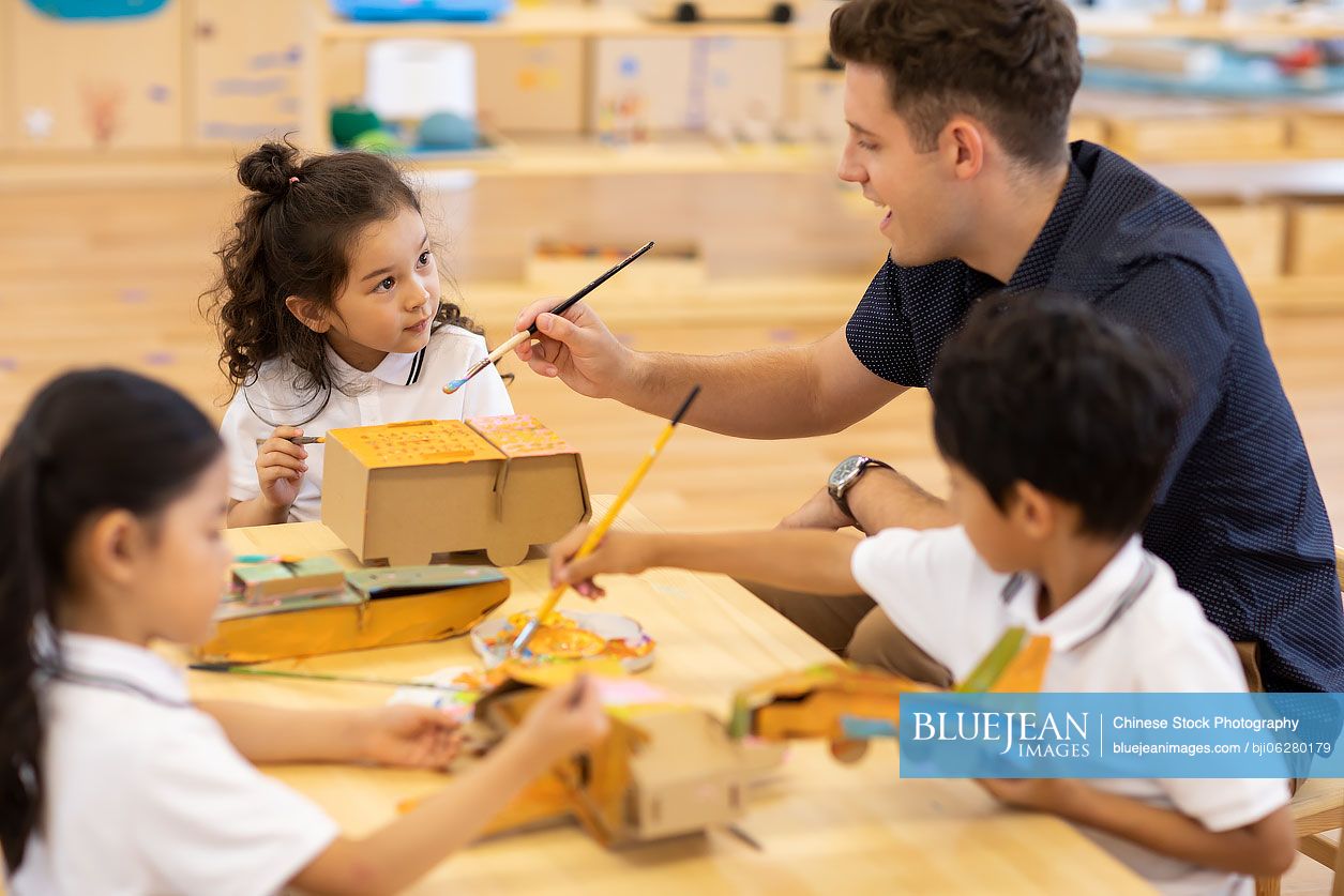 Foreign teacher teaching art class in classroom