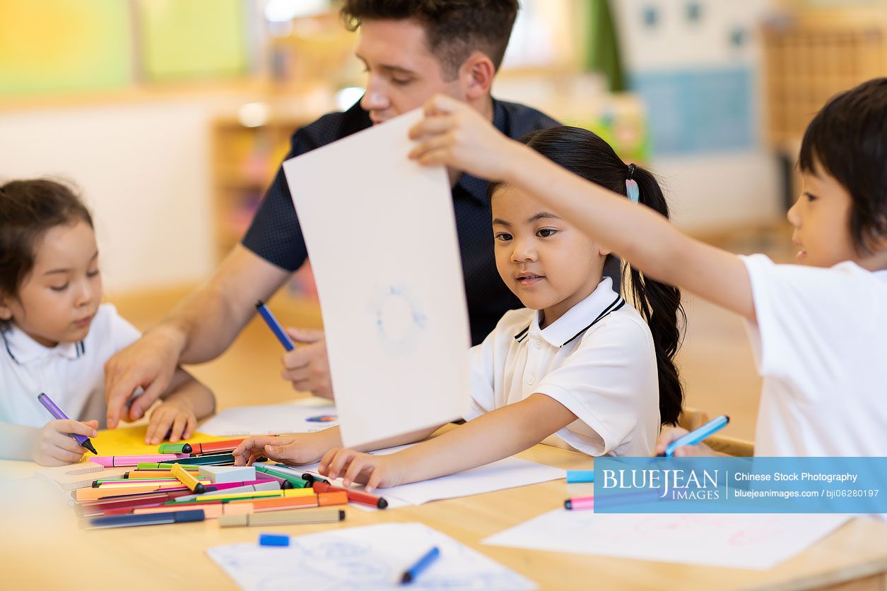 Foreign teacher teaching art class in classroom