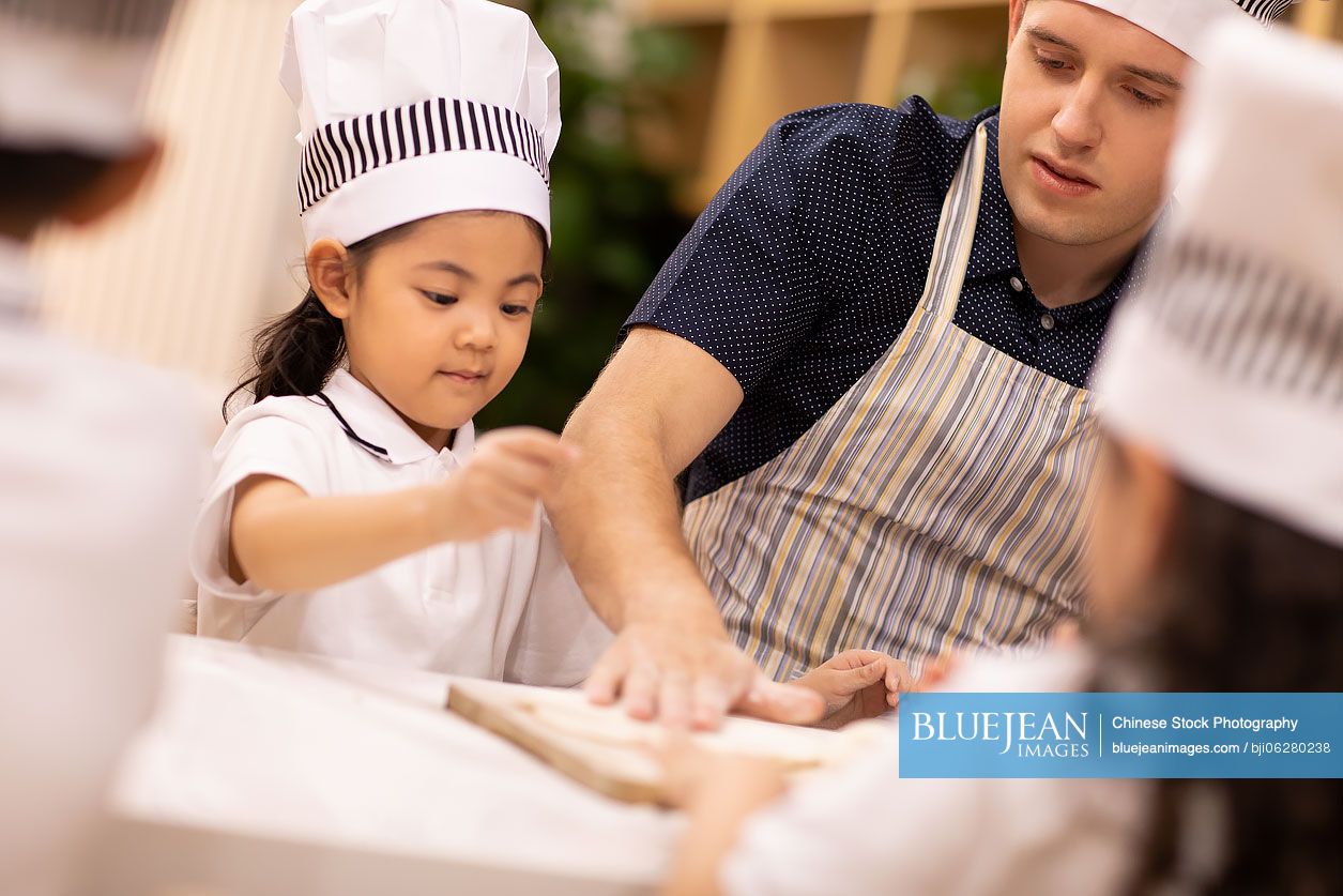 Children learning cooking in classroom