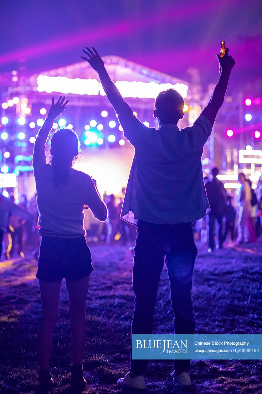 Young Chinese couple at music festival