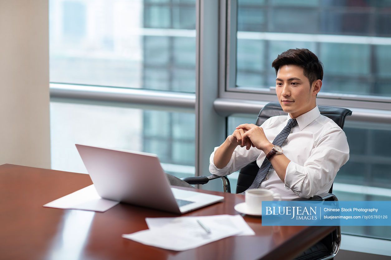 Confident Chinese businessman working in office-High-res stock photo ...