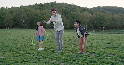 Happy young Chinese family jumping ropes outdoors,4K