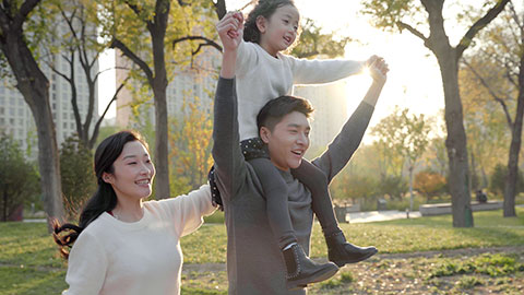Happy young Chinese family having fun in park,4K