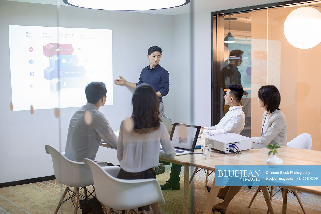 Chinese business people having meeting in board room 