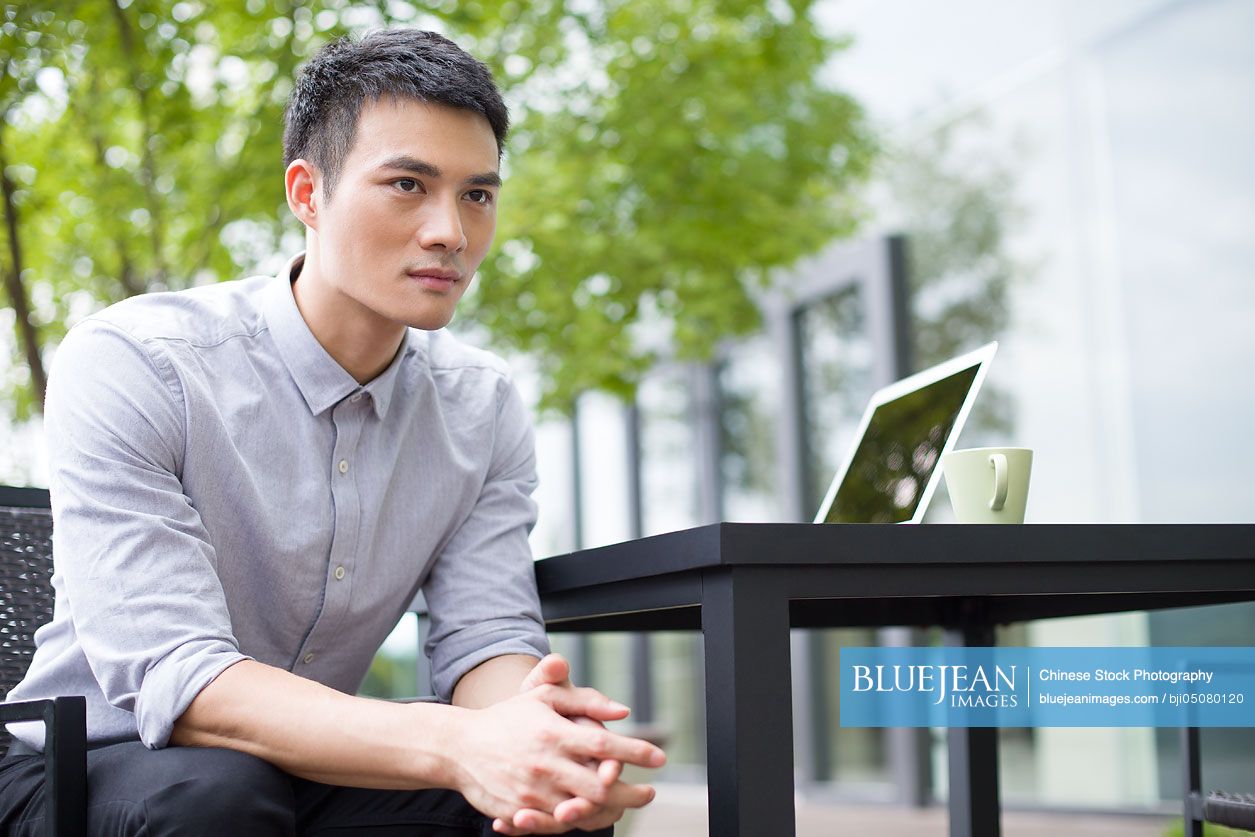 Young Chinese businessman thinking