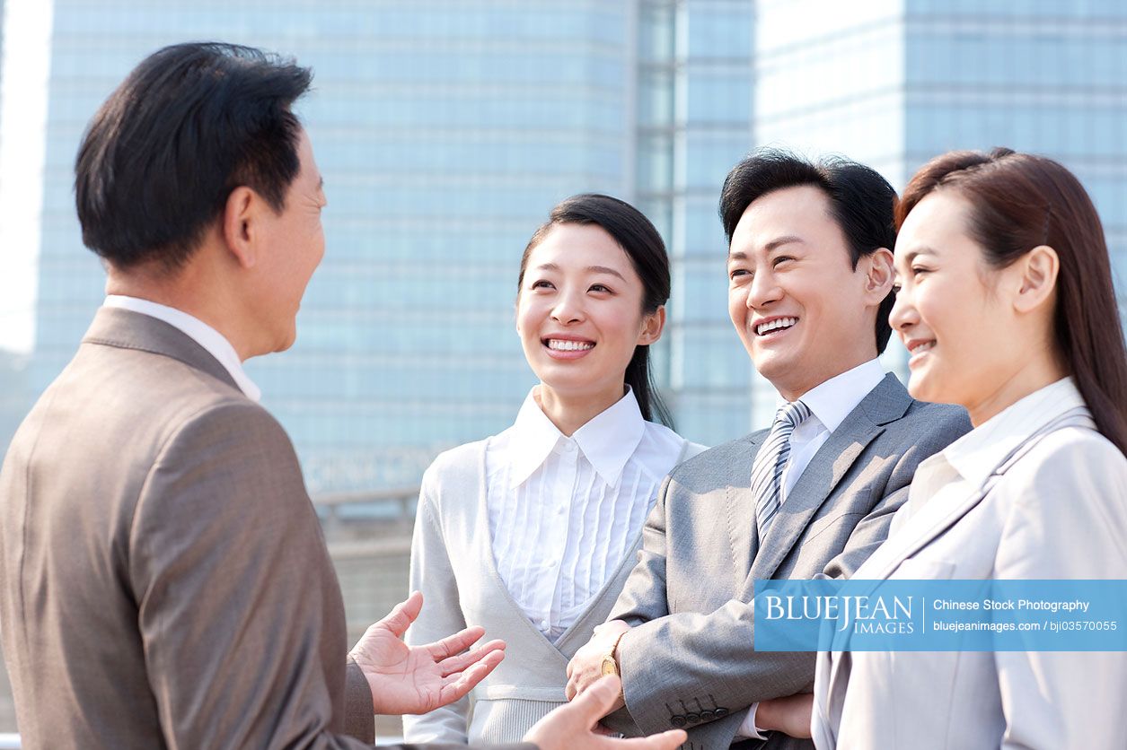 Cheerful Chinese business team in discussion