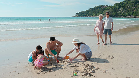 Happy Chinese family enjoying vacation on beach,4K