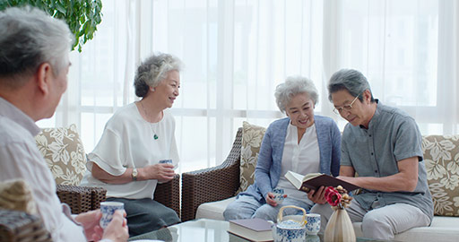 Happy senior Chinese friends talking in living room,4K