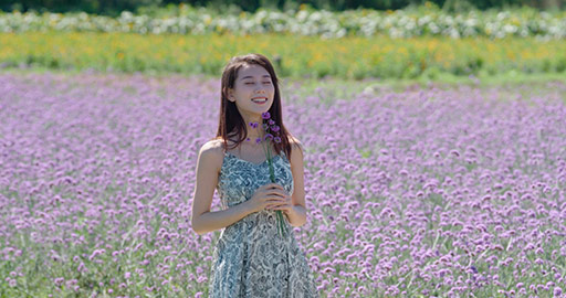 Happy young Chinese woman in flower field,4K