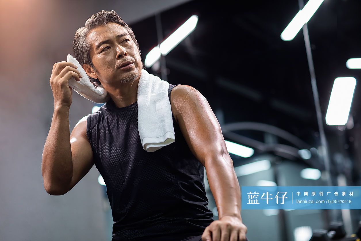 成熟男士在健身房擦汗