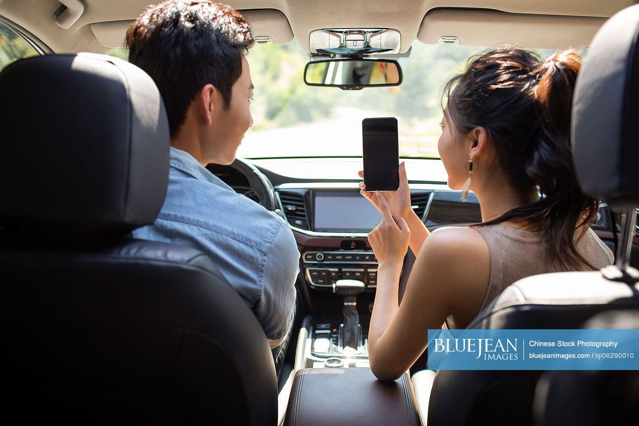 Young Chinese couple enjoying road trip