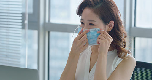 Young Chinese businesswoman wearing surgical mask in office,4K