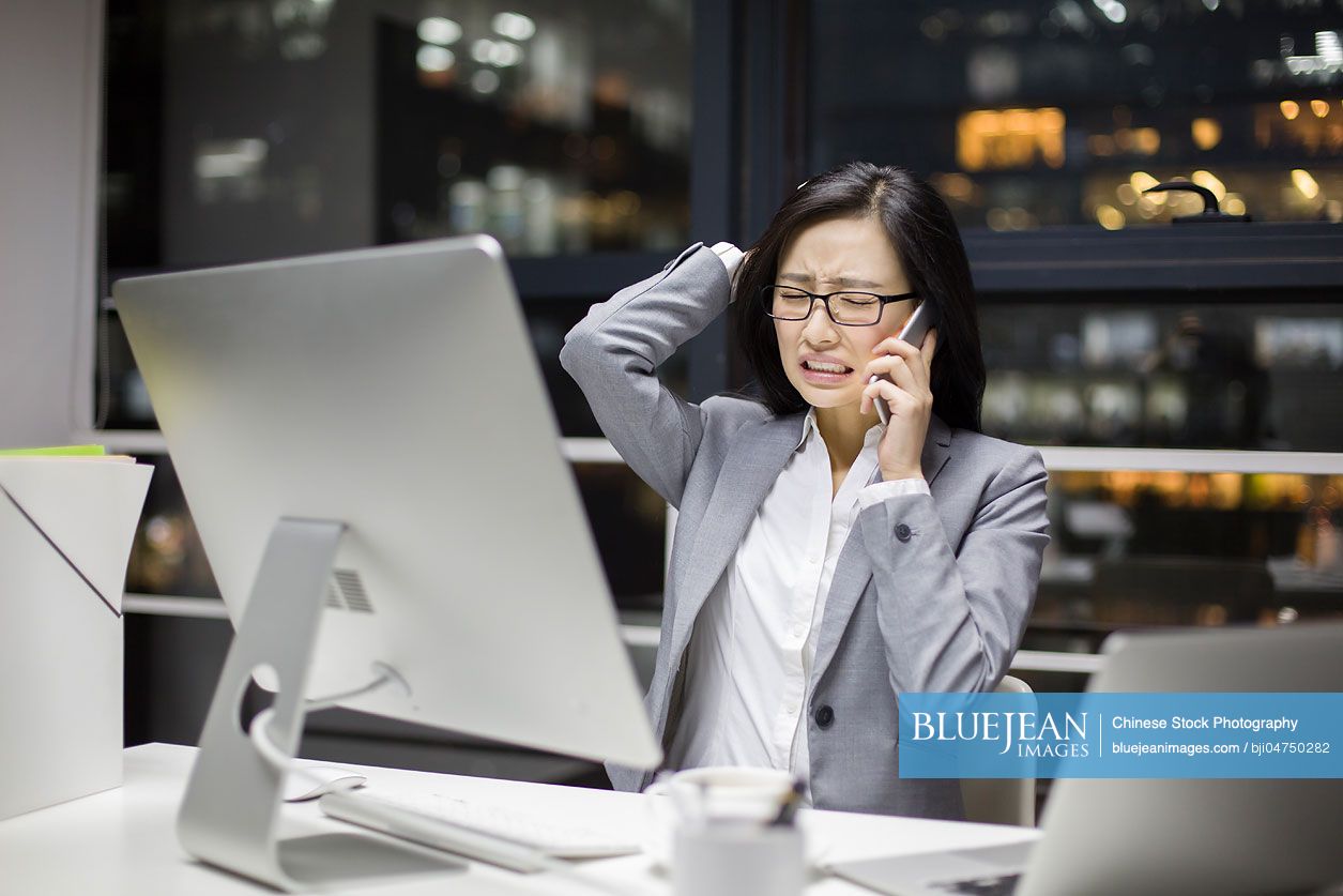 Chinese businesswoman working late in office