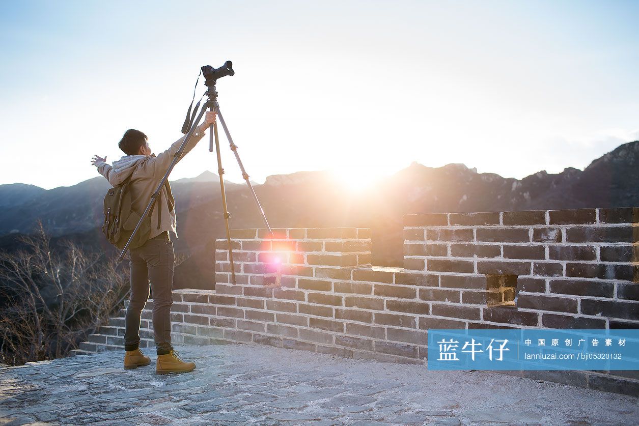 Young Chinese man photographing on the Great Wall