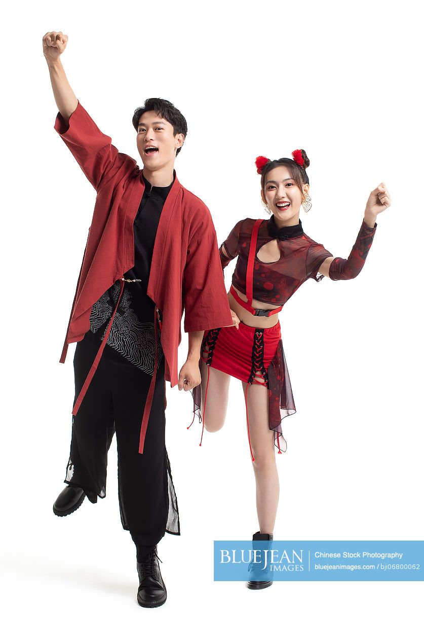 Studio shot of cheerful young Chinese couple