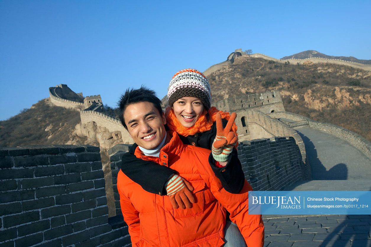 Chinese Man Giving Woman Piggy Back Ride On Great Wall Of China
