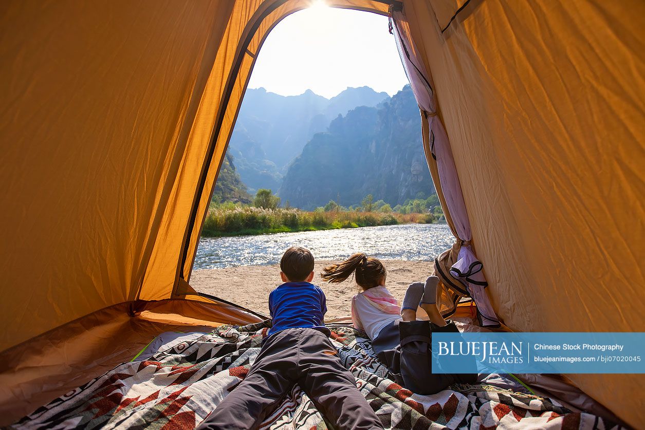 Cute Chinese Children looking out from tent