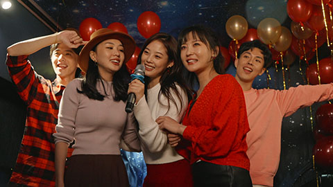 Happy young Chinese friends singing karaoke in nightclub,4K