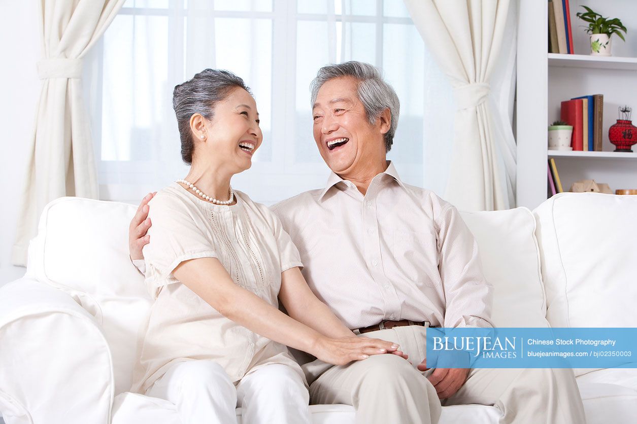 Happy senior Chinese couple laughing