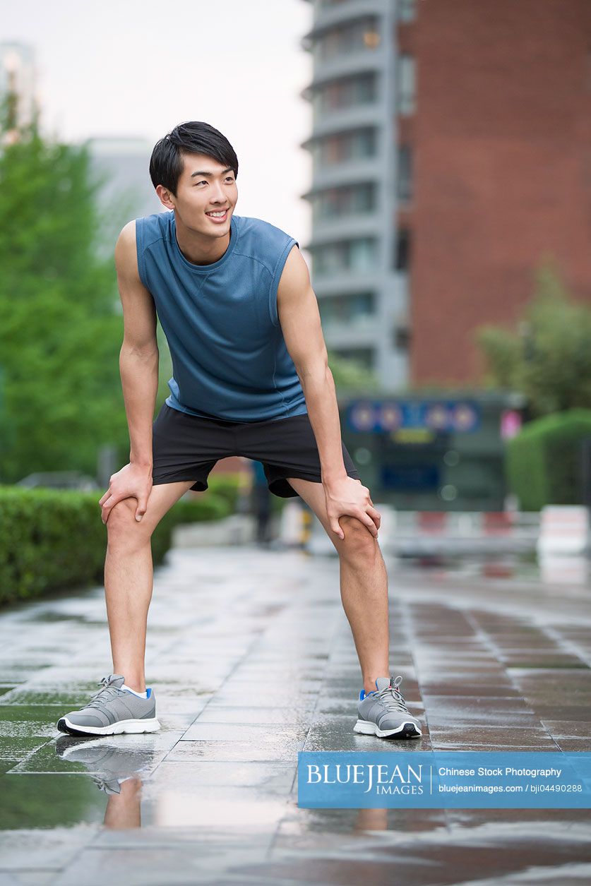 Young Chinese man taking a break from exercise