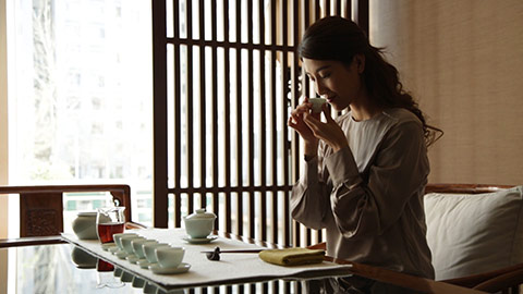 Happy young Chinese woman drinking tea,HD