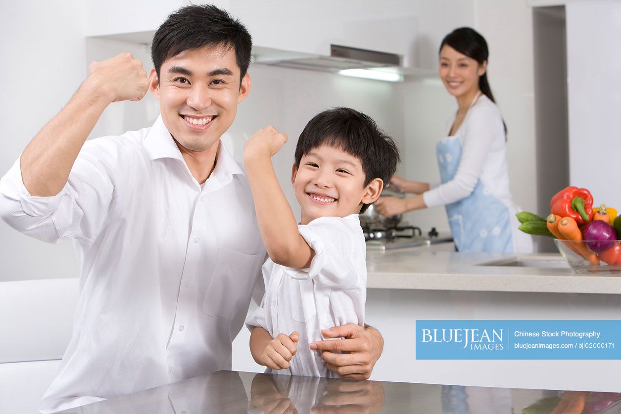 Young Chinese family in modern kitchen