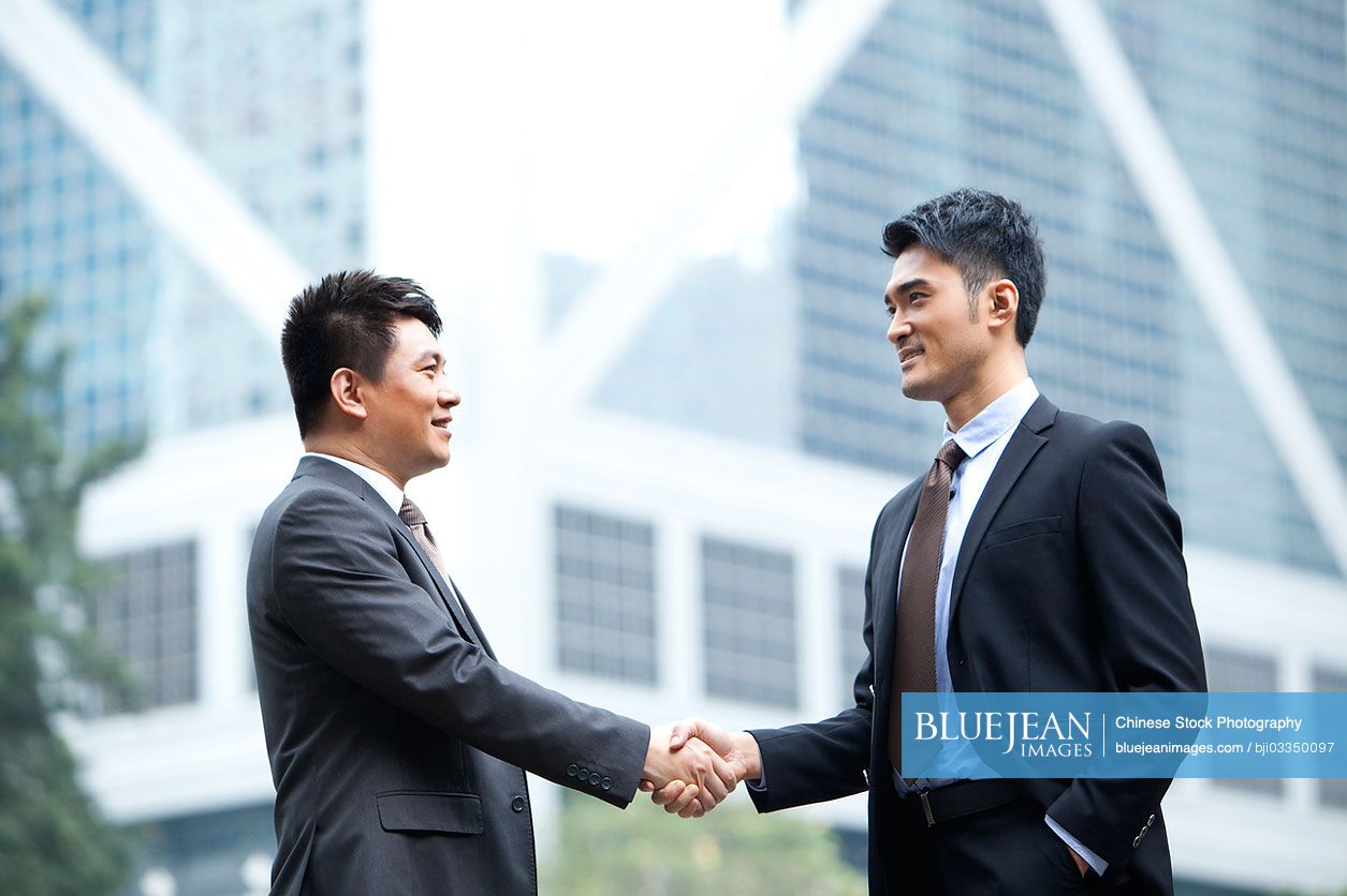 Professional Chinese businessmen shaking hands, Hong Kong