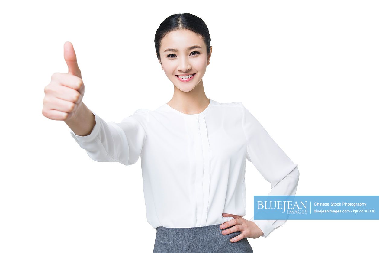 Young Chinese woman giving thumbs up