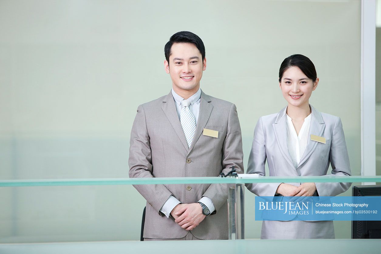 Chinese business persons at front desk