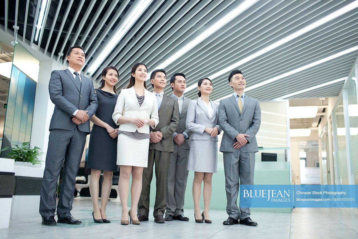 Confident Chinese business team looking at view