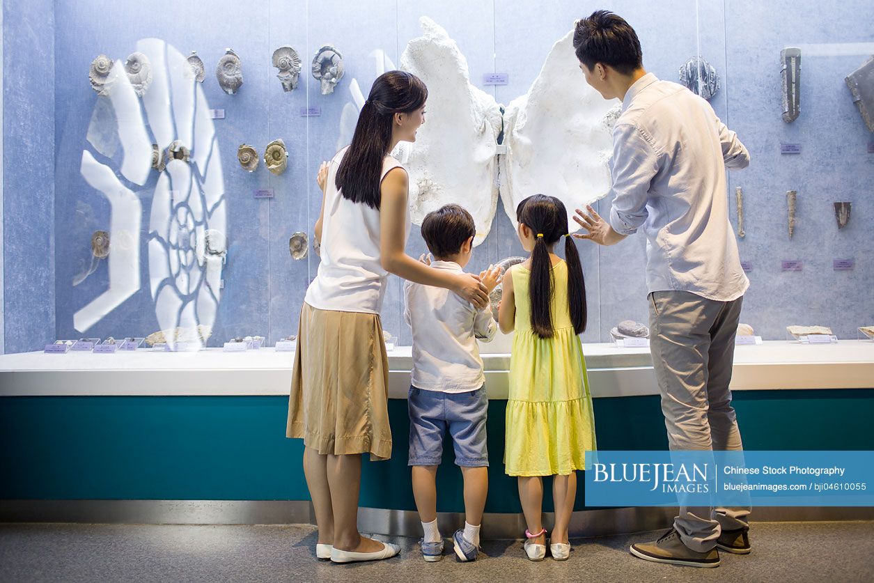 Young Chinese family in aquarium